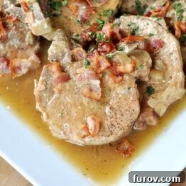 Smothered Pork Chops slow cooked to perfection, served with rich gravy