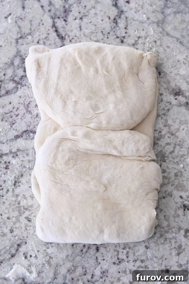 Dough folded into thirds for twisted croissant bread.