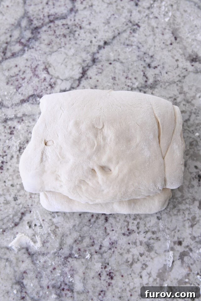 Folded dough for cinnamon sugar croissant bread.