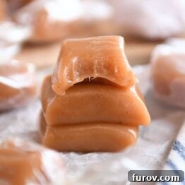 Three apple cider caramels stacked on parchment.