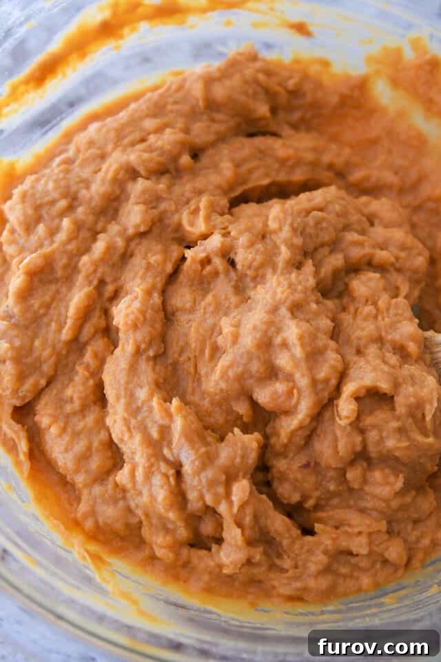 Sweet Potato Pecan Crumble Bake 4 A glass bowl filled with the smoothly mixed, creamy sweet potato filling, ready for baking.