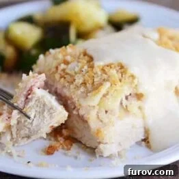 A delicious piece of easy chicken cordon bleu with sauce.