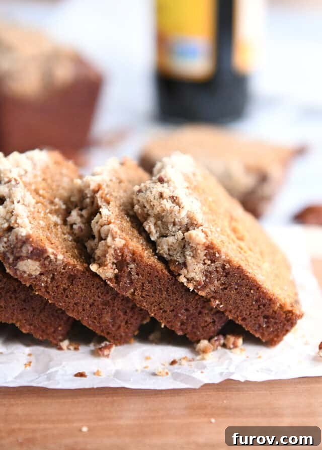 Three slices of gingerbread mini loaf with streusel, showcasing the moist crumb and delicious topping.