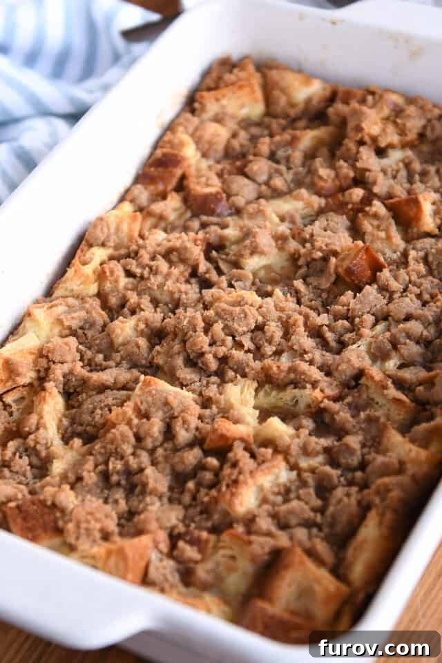 Cinnamon Streusel French Toast Casserole 7 Baked French toast bake in white pan.