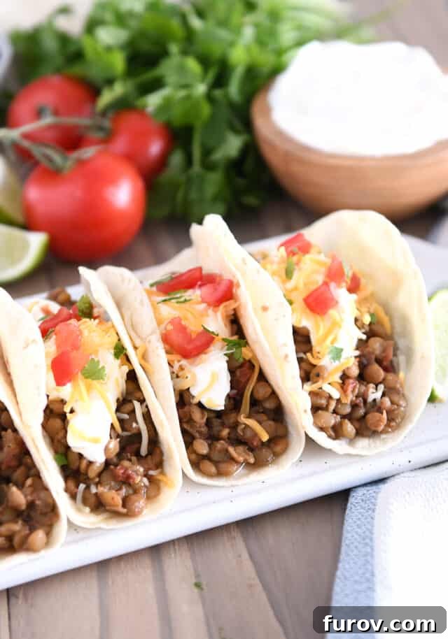 One-Pot Wonder Lentil Tacos 7 Three tacos of flour tortillas filled with cooked lentils, sour cream, cheese and tomatoes.