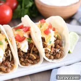 One-Pot Wonder Lentil Tacos 9 Three tacos of flour tortillas filled with cooked lentils, sour cream, cheese and tomatoes.