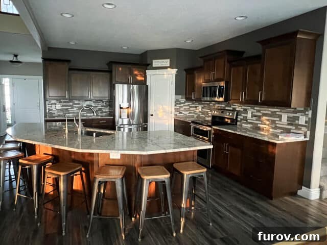 Friday Musings and Big Cookbook News 3 An older kitchen featuring brown cabinetry and gray countertops before renovation.