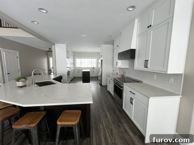 Friday Musings and Big Cookbook News 4 A beautifully renovated modern white kitchen with ample natural light.