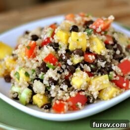 Delicious Mango and Black Bean Quinoa Salad served on a white plate with fresh ingredients