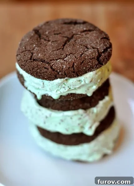 Stack of chocolate mint chip ice cream sandwiches on a white plate, showcasing their rich color and inviting texture.