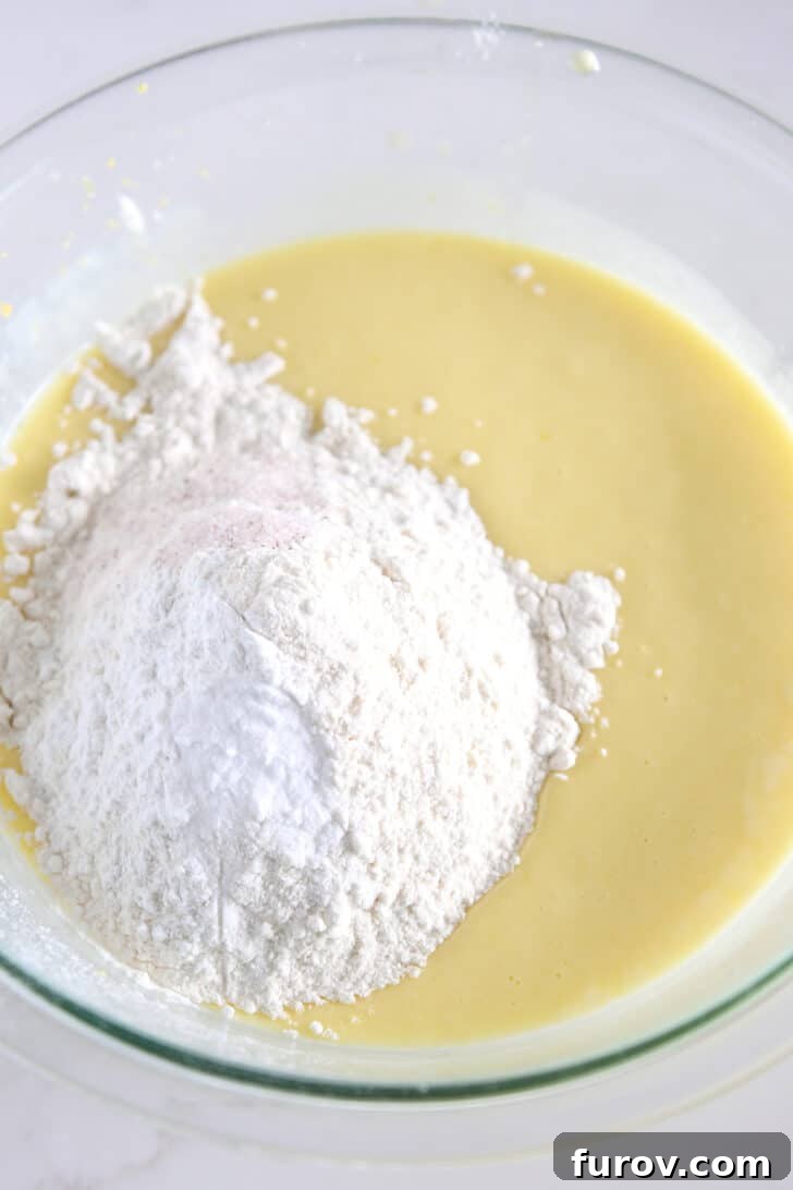 Cake batter in glass bowl with all-purpose flour, salt and baking powder.