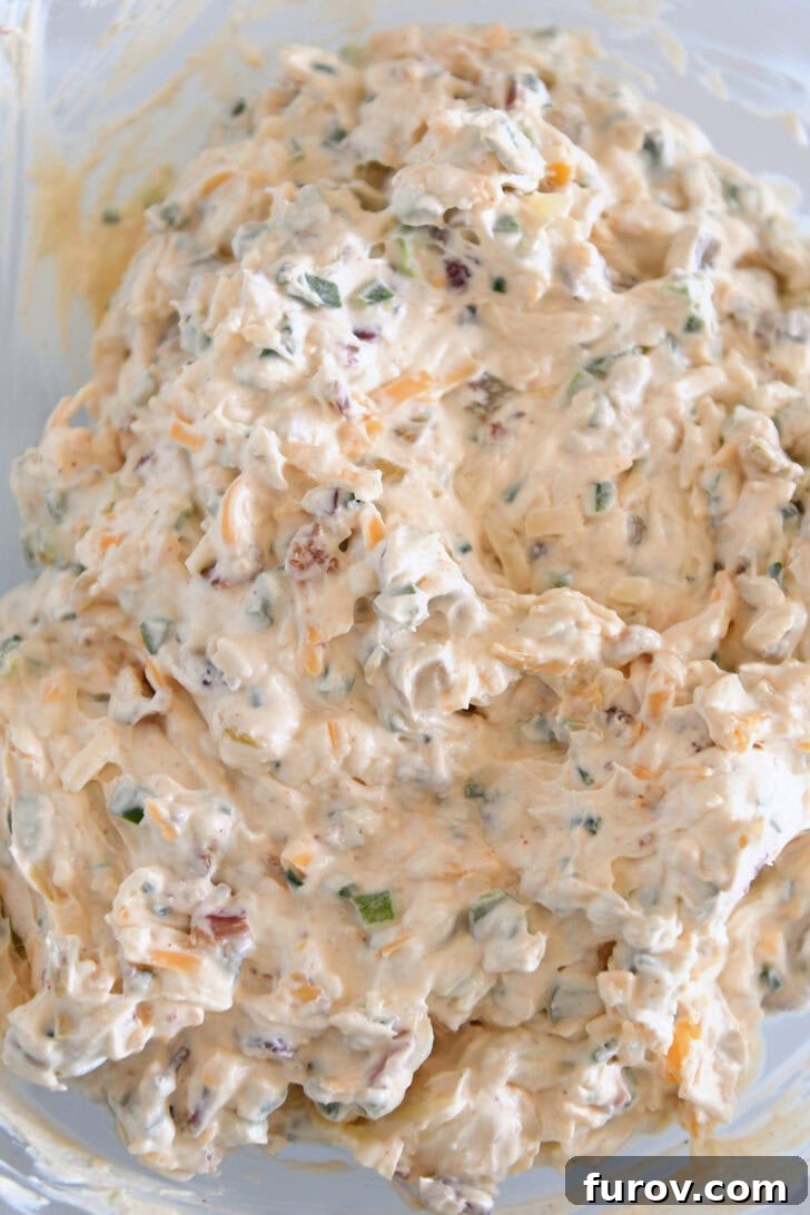 Glass bowl with creamy cheesy bacon jalapeno dip.