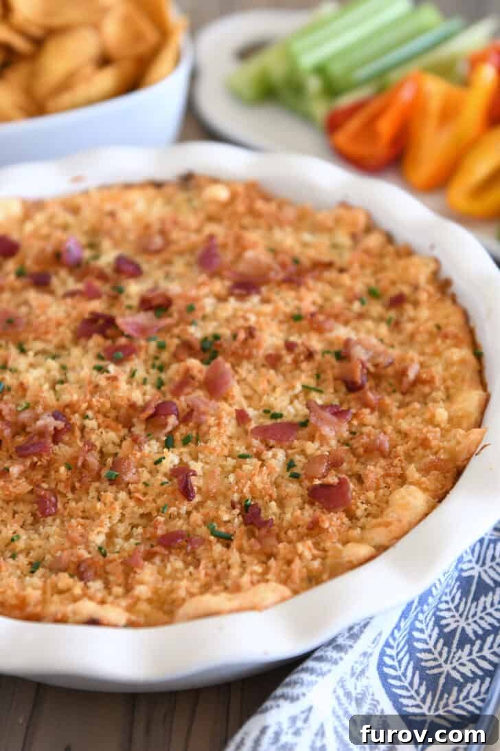 Baked bacon jalapeno popper dip in deep white pie plate.
