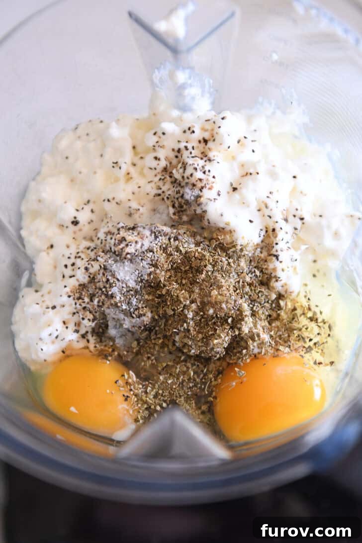 Ultimate Dutch Oven Lasagna 3 Blender filled with cottage cheese, eggs, basil, oregano, salt, and pepper, ready for blending.