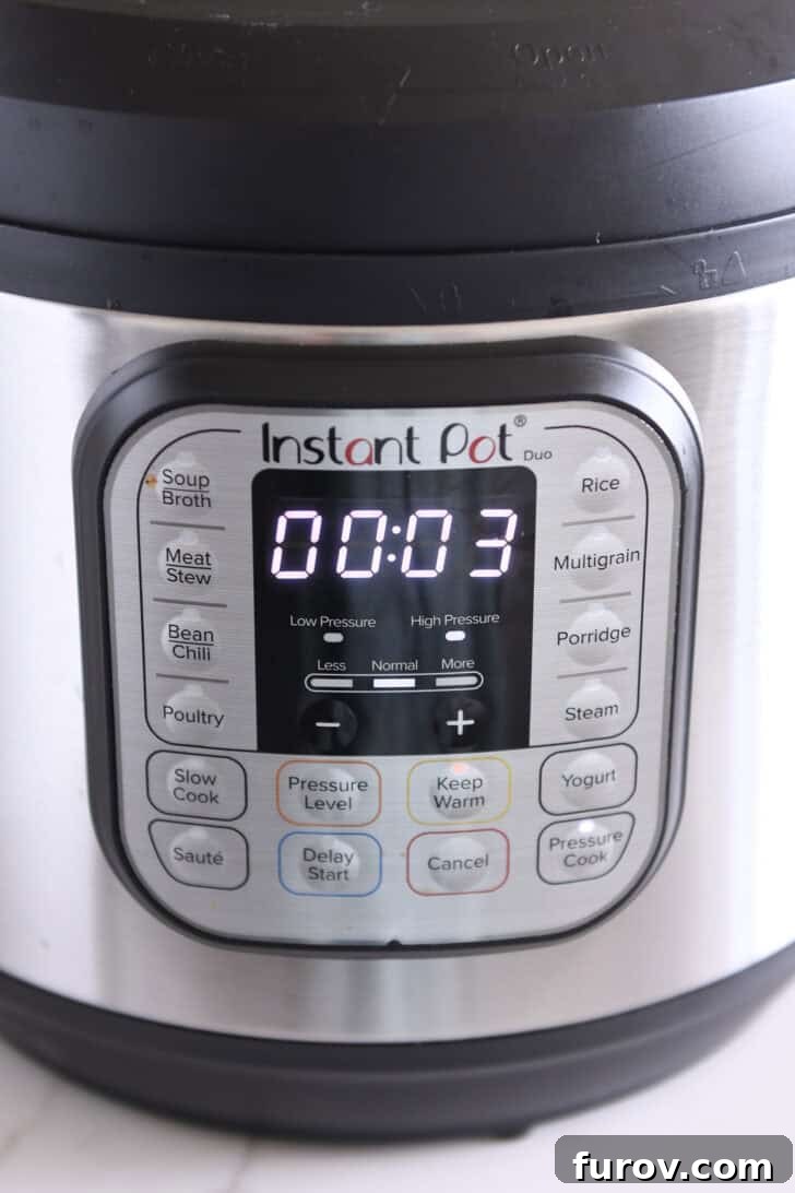 The Instant Pot display showing a timer set for three minutes, indicating the precise cooking time for the pasta.