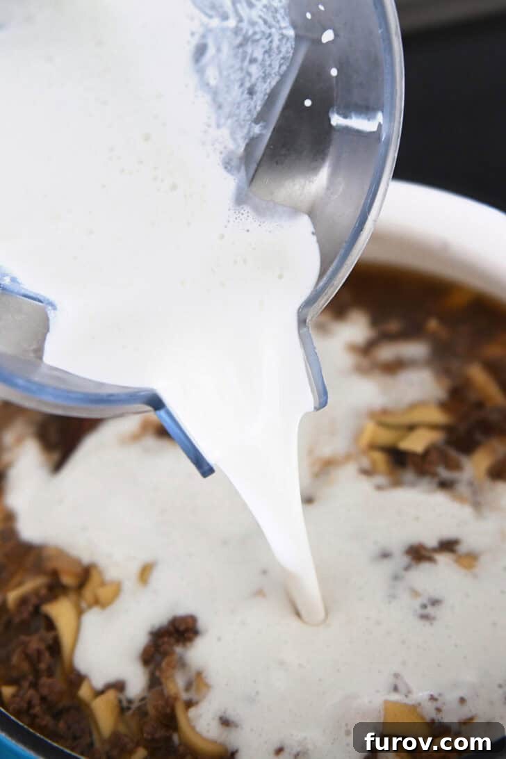 Pouring a milky mixture into the soup pot to thicken it.
