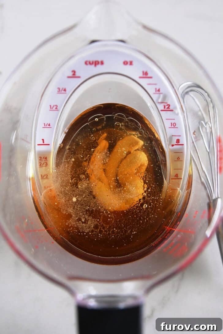 2-cup liquid measuring cup with vinegar and mustard.
