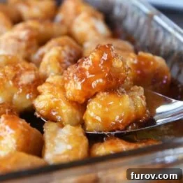 Tangy Honey Glazed Chicken 12 A close-up shot of a plate of baked sweet and sour chicken, garnished and ready to serve.