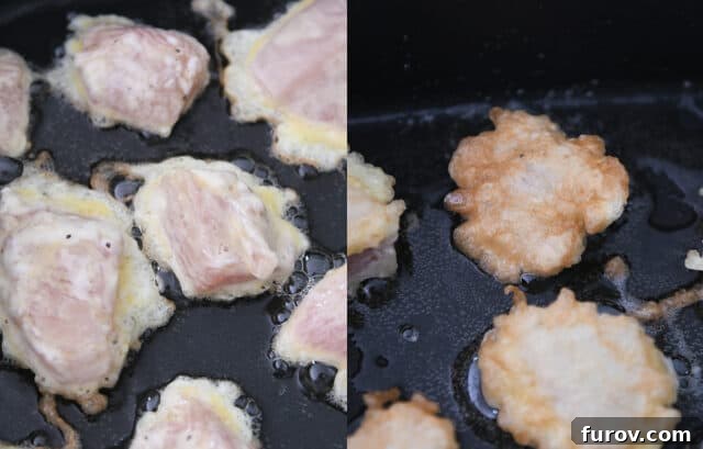Tangy Honey Glazed Chicken 7 Cornstarch and egg-coated chicken pieces sizzling in a hot skillet, developing a golden crust.
