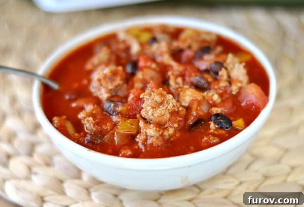 Comforting Turkey and Bean Chili 3 Top view of a white bowl with black bean turkey chili.