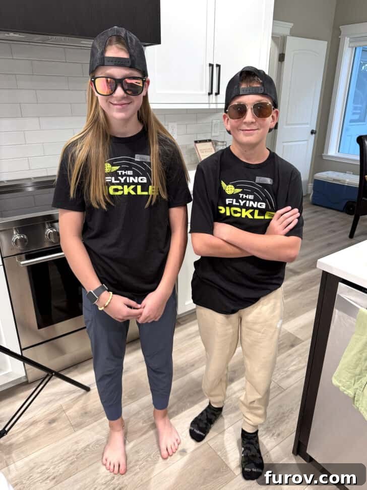 Two students smiling at a Homecoming dinner table