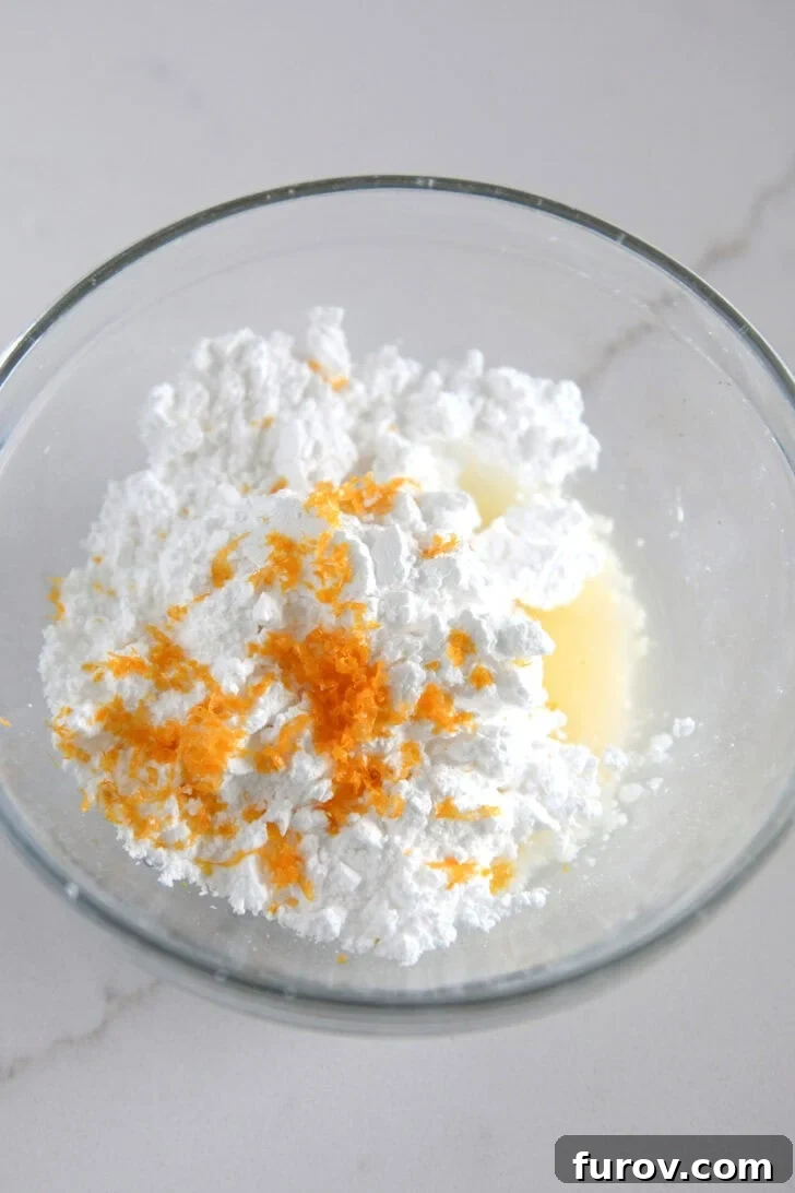 Sunburst Cranberry White Chocolate Scones 11 Small bowl with powdered sugar, orange juice and orange zest.