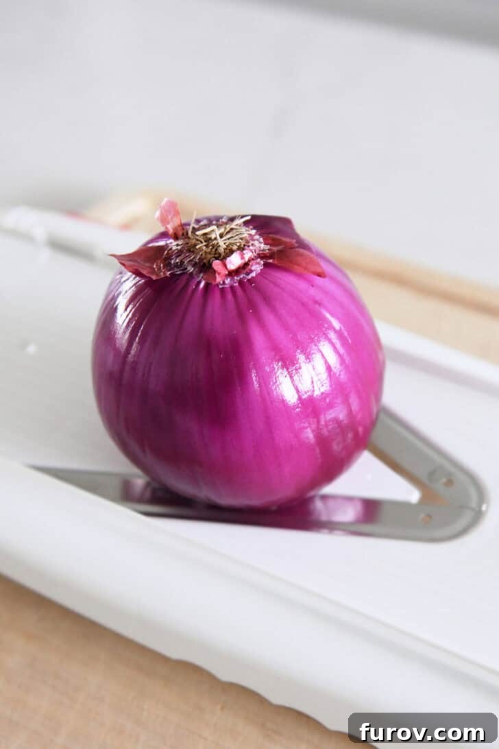 Red onion on mandoline slicer.