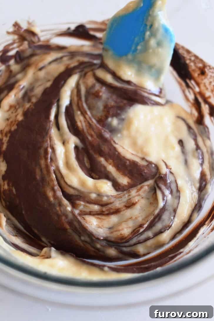 Marbled Chocolate Banana Muffins 6 A harmonious blend of banana muffin batter subtly swirled with the chocolate mixture in a glass bowl, illustrating the beautiful two-tone effect.