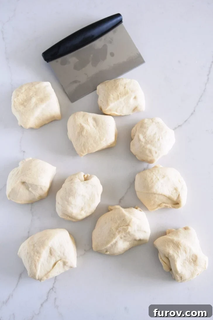 Dough cut into eight pieces with bench scraper.