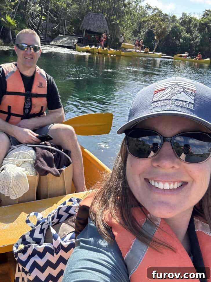 Friday Focus: My Current Chapter 7 Husband and wife enjoying a peaceful moment in a yellow canoe, wearing life jackets on calm water.