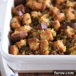 White 9X13-inch pan with baked sausage and herb stuffing.