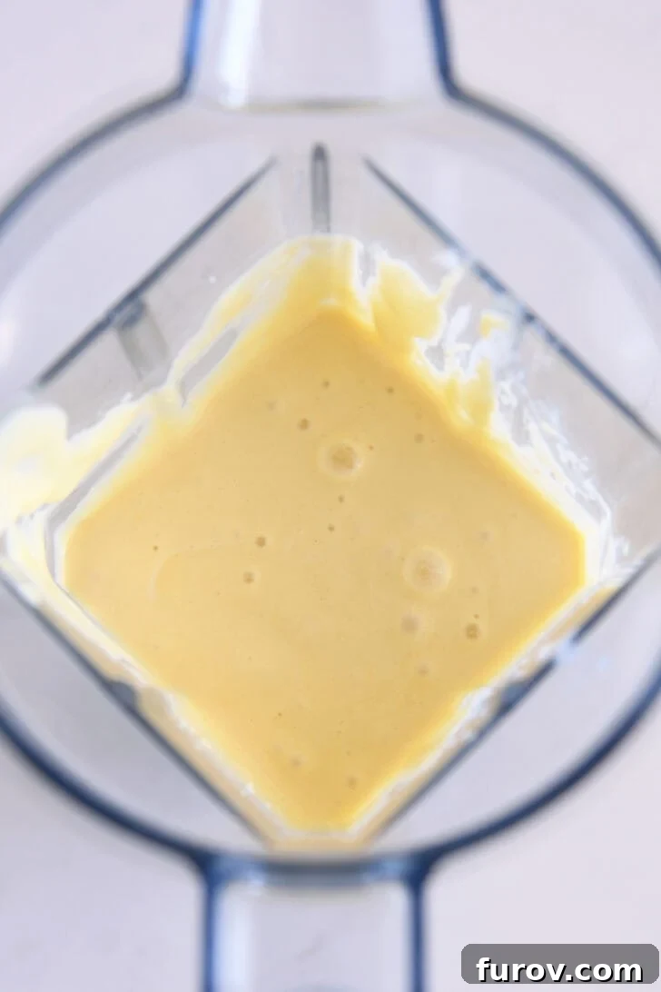 Top down view of smooth cottage cheese pancake batter in blender after blending.