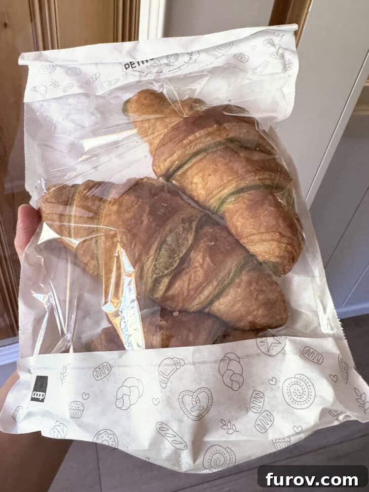 Three pistachio croissants in cellophane bag, with text that mentions Mel's Kitchen Cafe Friday Thoughts.