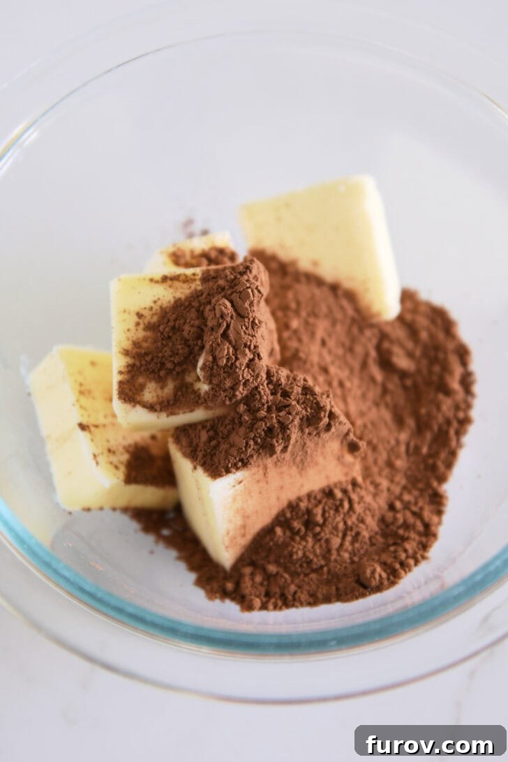 Velvet Chocolate Perfection 3 A glass bowl brimming with softened butter and dark cocoa powder, ready to be combined into the luscious pie filling.
