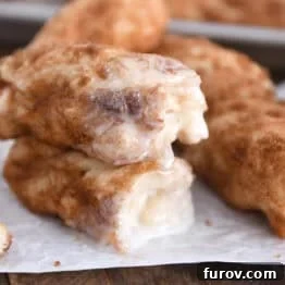 Two half cinnamon twists dipped in icing and stacked on each other.