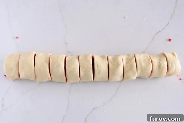 Raspberry sweet roll log cut into 12 pieces.