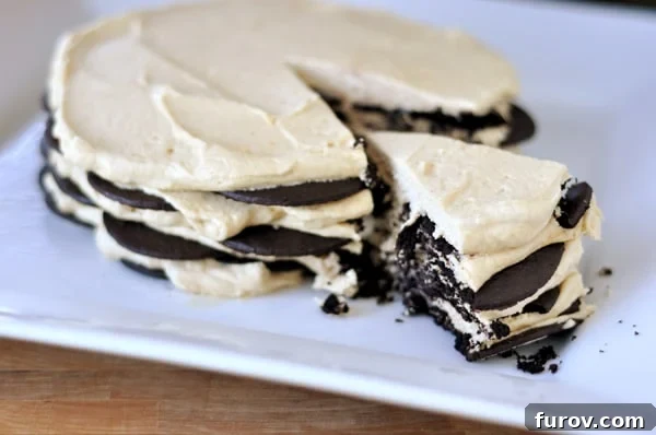 Peanut Butter Chocolate Wafer Delight 2 A beautifully presented chocolate and peanut butter wafer cream cake with a perfect slice removed, showcasing its delightful layers, resting on a pristine white platter.