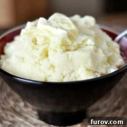 A smaller image of the roasted garlic and parmesan mashed potatoes in a serving bowl.