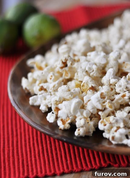 Spice-topped popped popcorn on a brown plate, highlighting the vibrant seasoning.