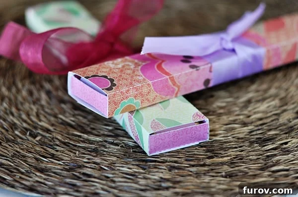 A pair of vibrant, long paper chocolate boxes, elegantly tied with coordinating ribbons in the center, awaiting personalization.