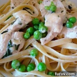 Fettuccine noodles with creamy chicken and peas.