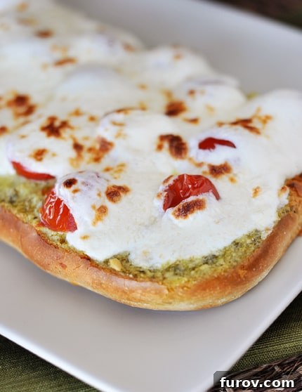 Make Your Own Crème Fraiche and Caprese Focaccia 3 A delicious slice of Caprese focaccia bread, topped with pesto crème fraîche, halved cherry tomatoes, and melted fresh mozzarella.