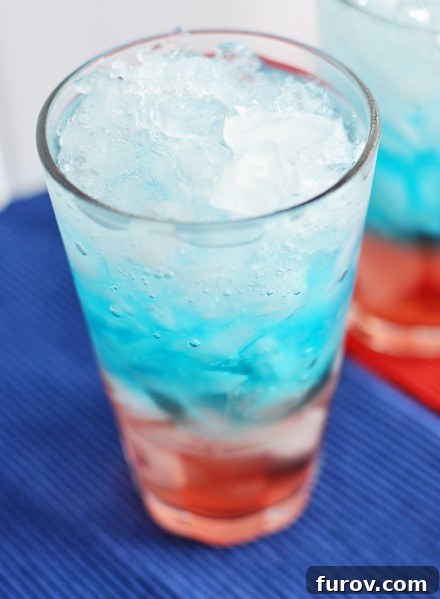 Close-up top view of a red, white, and blue layered drink, showcasing its distinct color layers and inviting appearance.