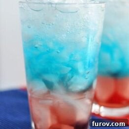 Close-up of a Red, White, and Blue Patriotic Drink with ice in a glass.