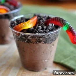 A beautifully presented homemade dirt pudding cup with a gummy worm, symbolizing a fun and easy dessert that's perfect for any occasion.