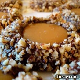 A plate of freshly baked Chocolate Turtle Cookies with golden caramel peeking from the center.