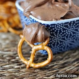 Brownie Batter Dip garnished with chocolate chips in a blue bowl.