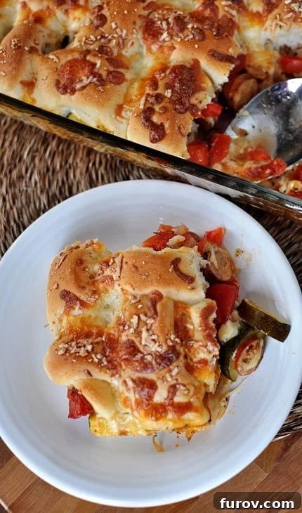 Top view of a bubbling pan of cheesy breadstick pizza casserole fresh from the oven, alongside a generous serving on a white plate, highlighting golden-brown breadsticks.