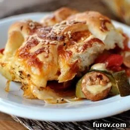 Cheesy breadstick pizza casserole on a white plate.
