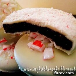 White chocolate dipped peppermint cookie with a bite taken out, showing the rich chocolate base and festive peppermint crunch.